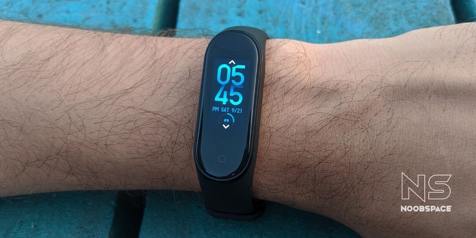 A blue digital clock custom band face on Mi Band 4