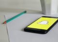 A phone with Snapchat logo on a table