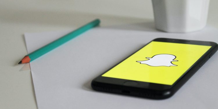 A phone with Snapchat logo on a table