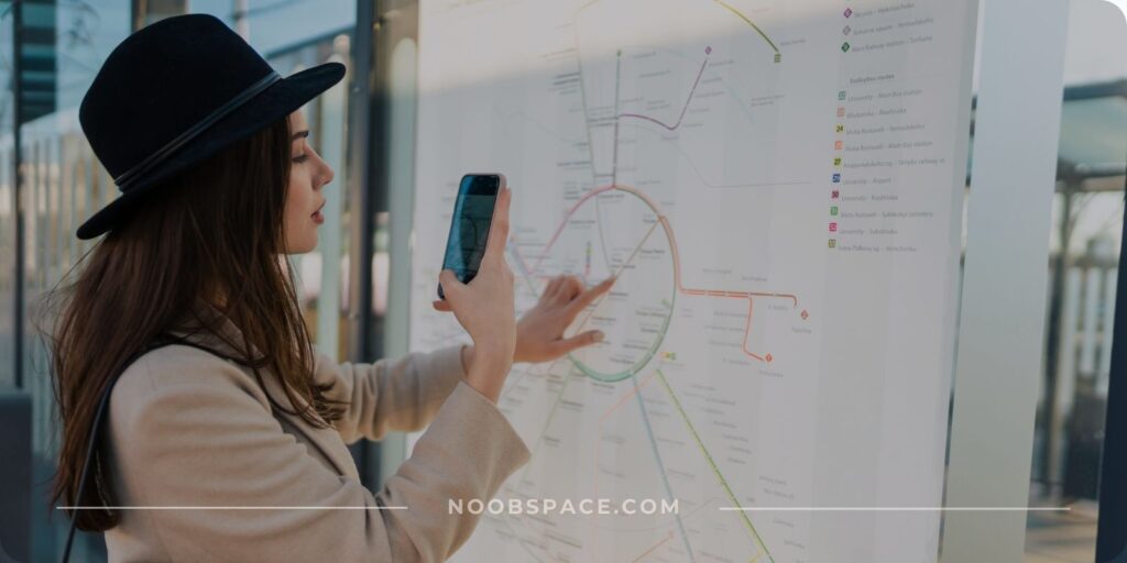 A woman using her phone to navigate in a public transportation area