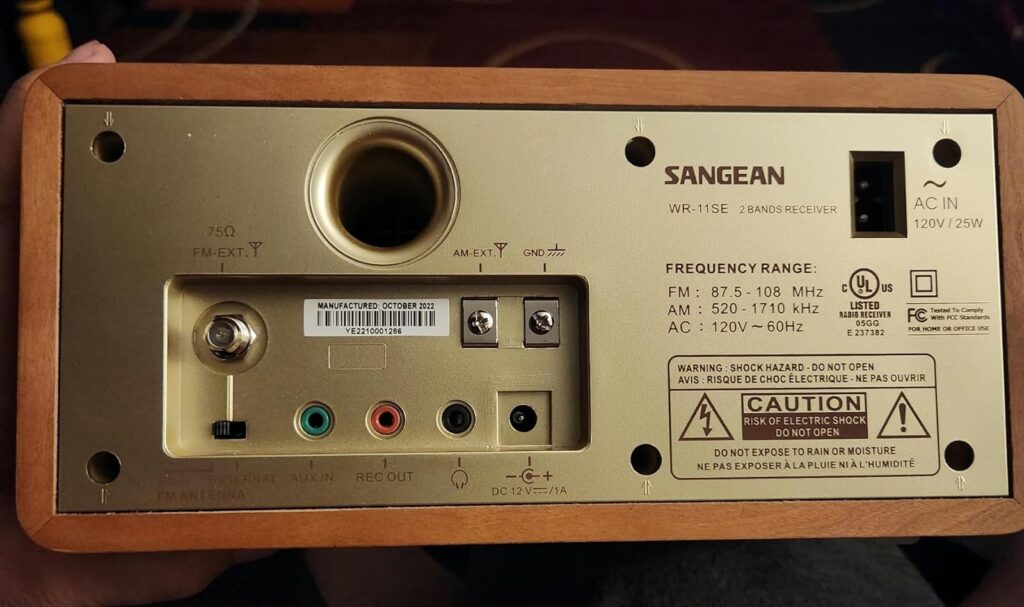 A photo of back view with cords of Sangean WR-11 AM/FM radio